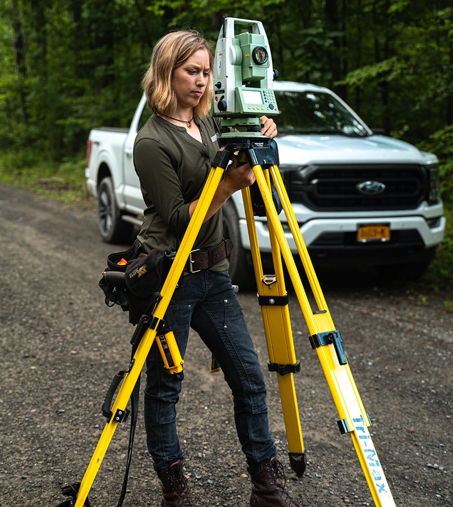 woman using survey equipment