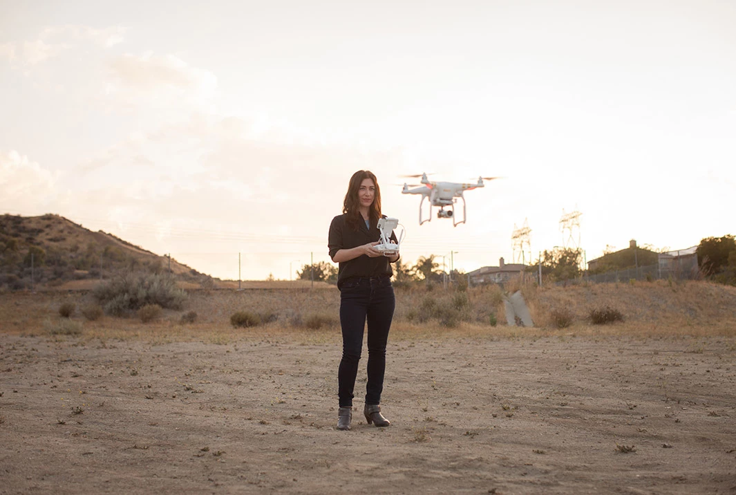 female drone operator on scrubland