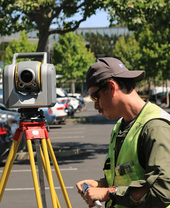 Geodesist at work in a parking lot