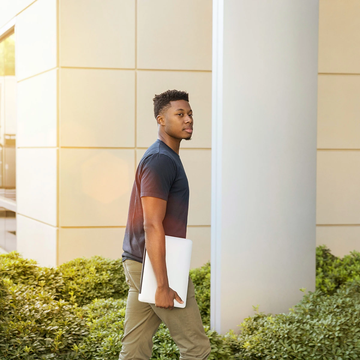 young man walking on a college campus